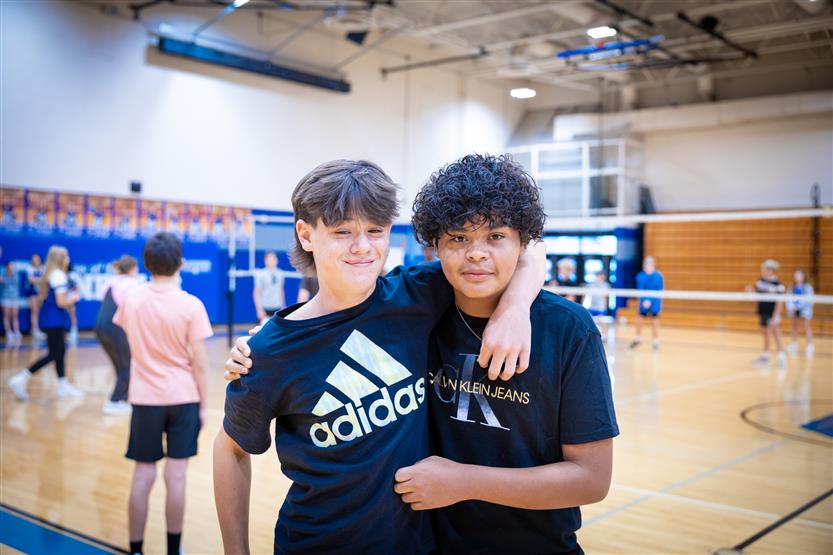 Students play volleyball in PE